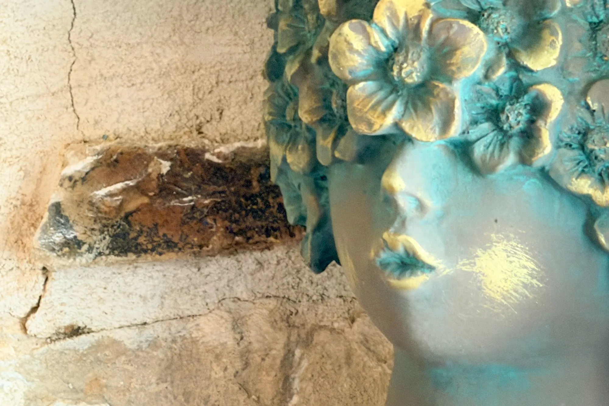 Art detail beside a stone wall