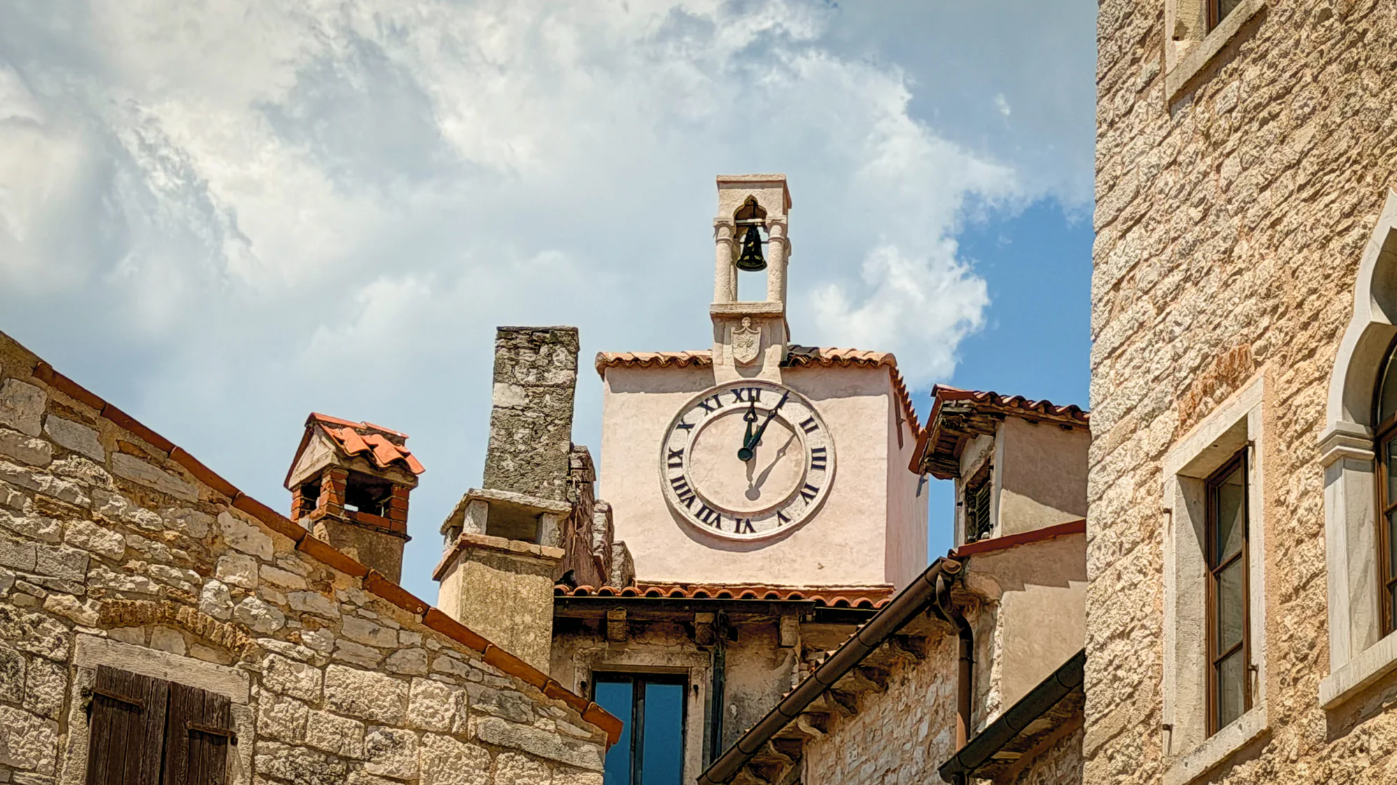 Clock tower and bell in the medieval old town of Bale, Istria