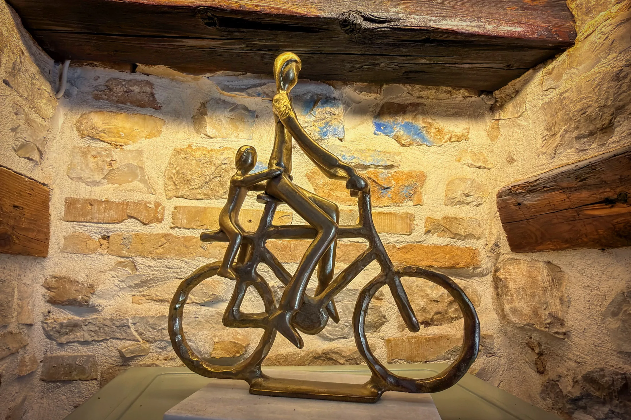 Bicycle sculpture in a stone niche in the living room