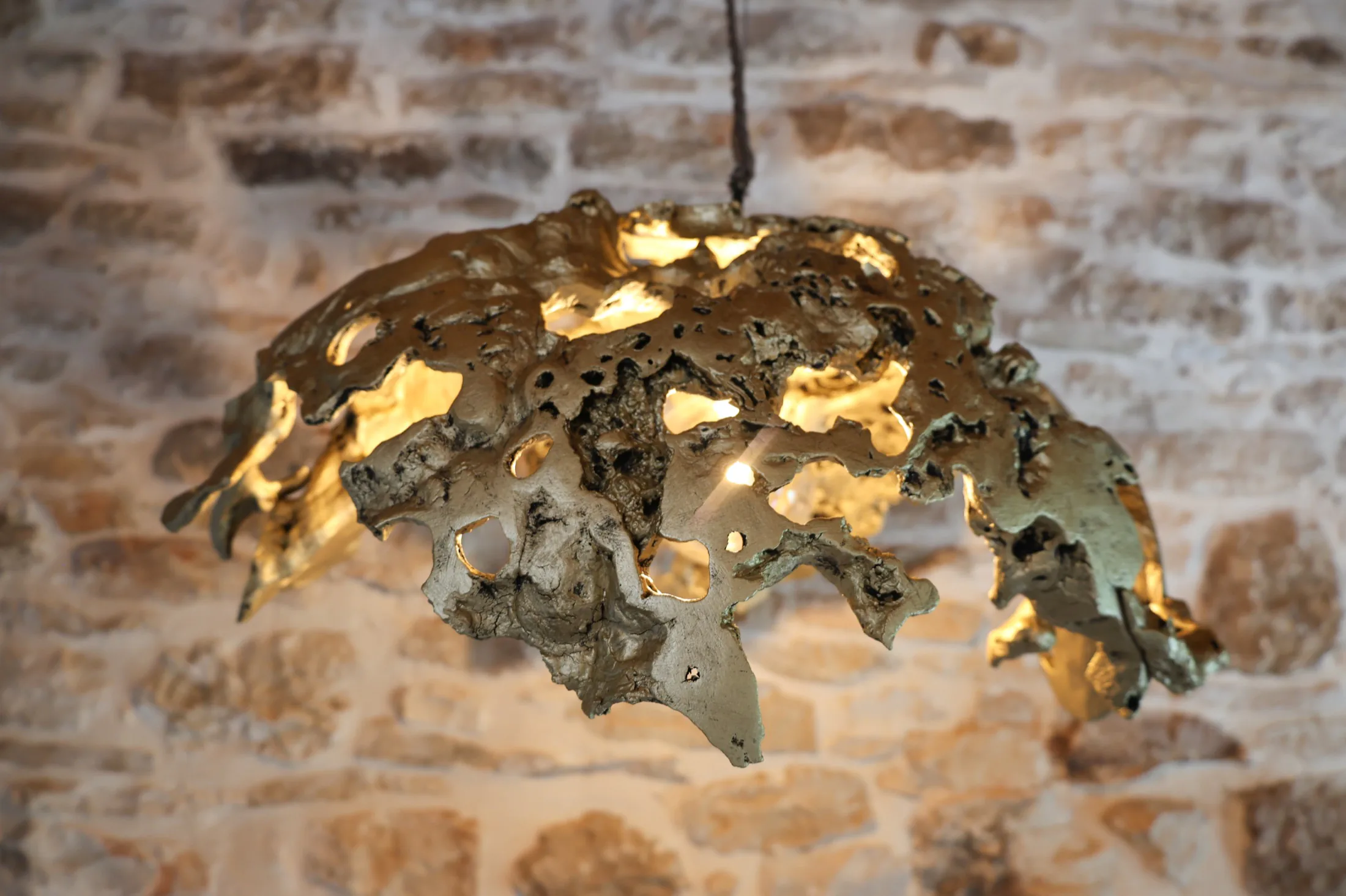 Sculptural light on a stone wall